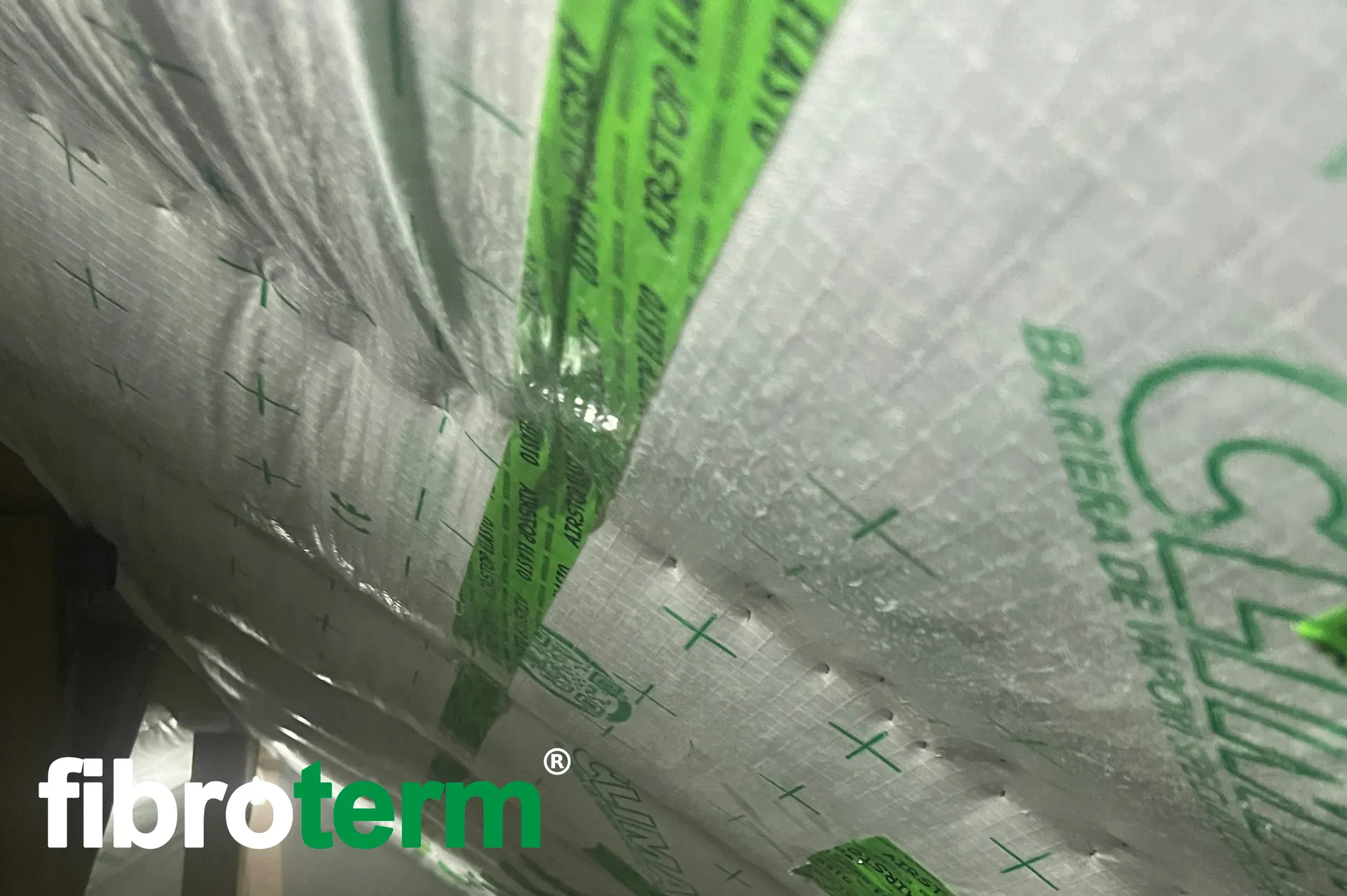 Detaliu: suprapunere de membrană barieră de vapori lipită cu bandă verde de etanșare